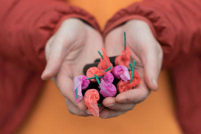 High angle view of woman holding pink flowers