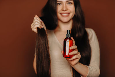 Close-up of woman holding bottle