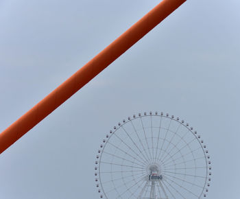 Low angle view of ferris wheel against clear sky