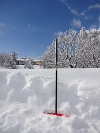 Scenic view of snow covered field against sky