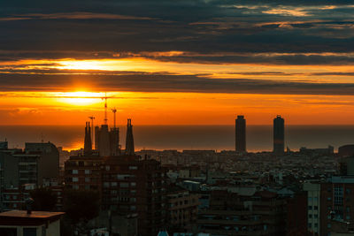 High angle view of buildings in city during sunset