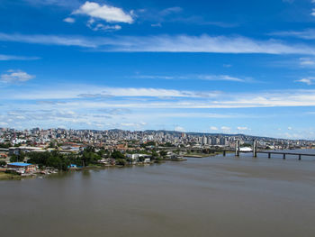 High angle view of townscape by sea against sky