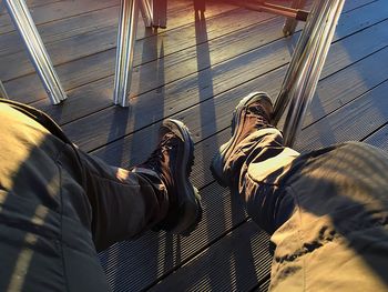 Low section of man standing on built structure