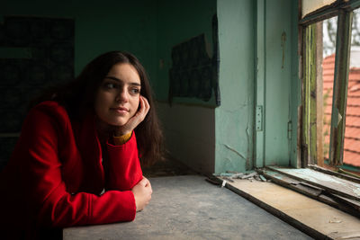 Thoughtful young woman sitting at home