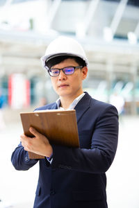 Close-up of architect wearing helmet working