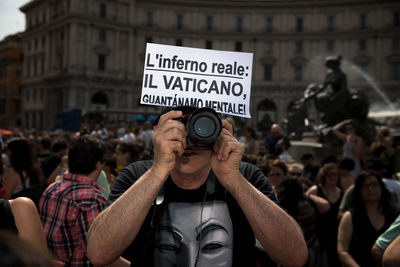 People photographing on street in city