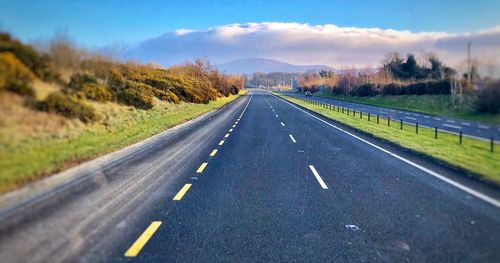 Surface level of country road against sky