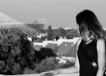 Rear view of woman sitting outdoors