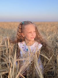 Portrait of young woman standing on field