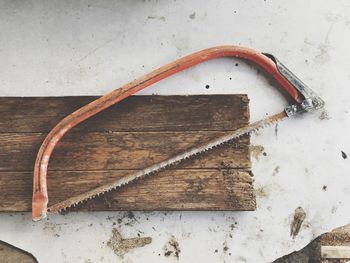 High angle view of hand saw on table