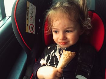 Close-up portrait of girl sitting in car