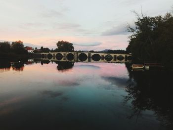 Scenic view of river against sky at sunset