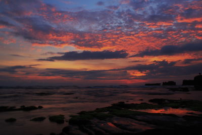 Scenic view of dramatic sky over sea during sunset