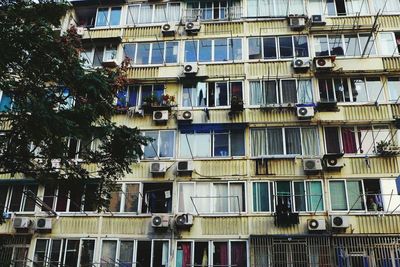 Low angle view building with windows and air conditioners