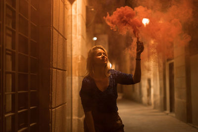 Full length of woman standing in city at night