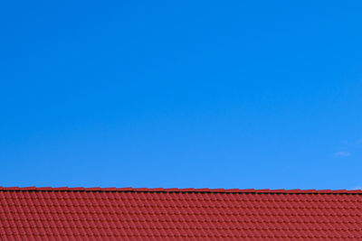 Low angle view of blue sky over roof