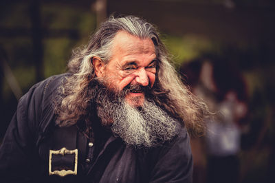 Cheerful bearded man with long hair