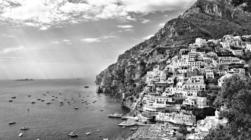 Scenic view of sea and buildings against sky