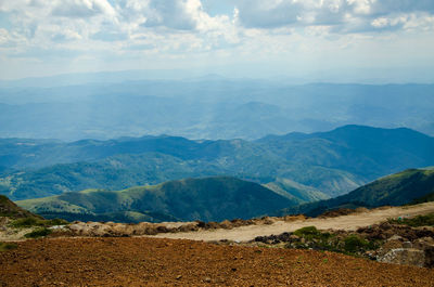 Scenic view of mountains against cloudy sky