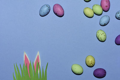 Close-up of multi colored candies against blue background