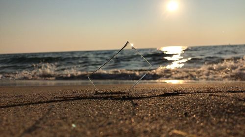 Close-up of sand on beach against clear sky