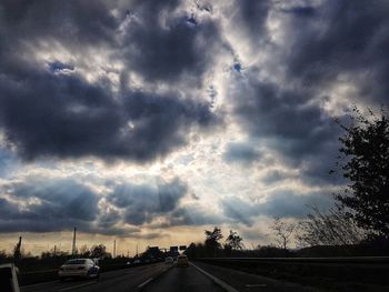 Car on road against dramatic sky