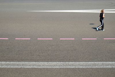 Woman standing on road