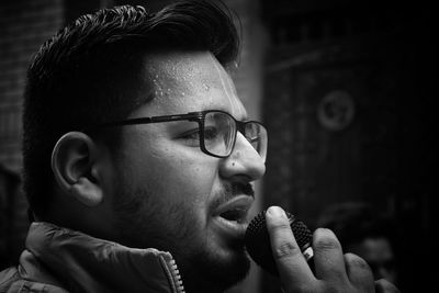 Close-up of man singing at music concert