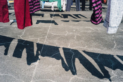 Shadow of clothes drying on clothesline at building terrace