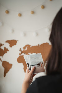 Rear view of woman hand on paper