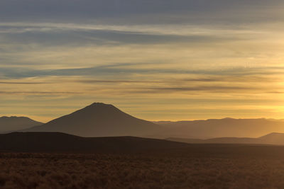 Scenic view of silhouette mountains against sky during sunset