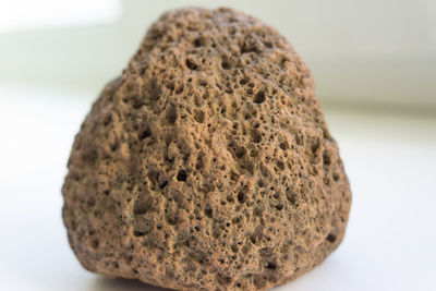 Close-up of bread on table against white background