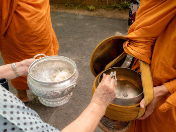 Midsection of people holding drink