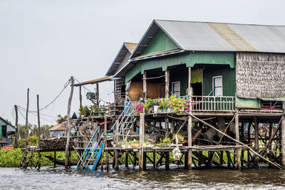 Building by river against clear sky