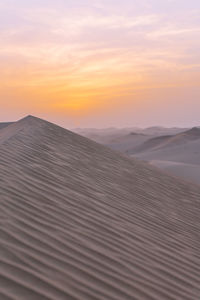 Scenic view of desert against sky during sunset