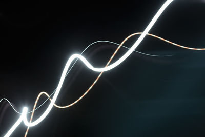 Close-up of light bulb over black background