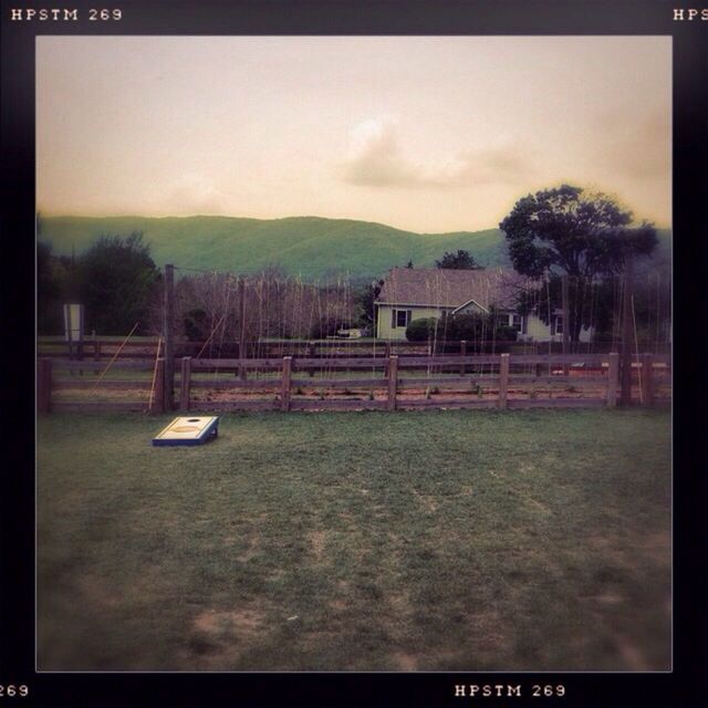 transfer print, auto post production filter, tree, sky, mountain, landscape, tranquil scene, tranquility, nature, scenics, field, outdoors, built structure, grass, mountain range, beauty in nature, no people, day, non-urban scene, cloud - sky