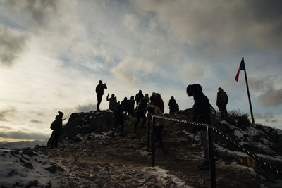 People at beach against sky