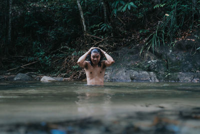 Portrait of young woman in water