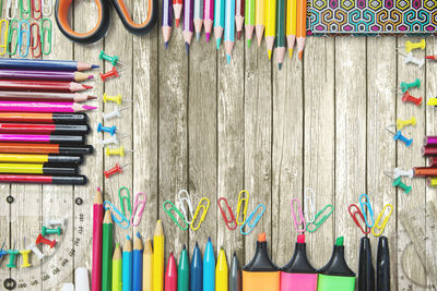 Directly above shot of multi colored school supplies on table