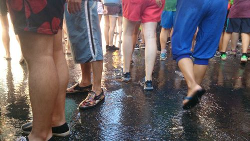 Low section of people standing on tiled floor