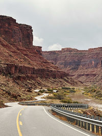 Road leading towards mountains against sky