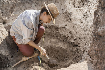 Archaeologist uncovering artifacts remains