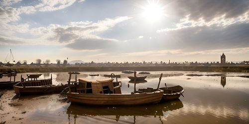 Boats moored at harbor during sunset