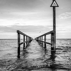 Pier over sea against sky