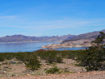 Scenic view of mountains against blue sky