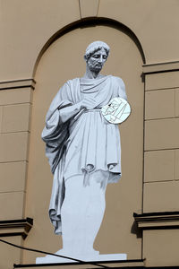 Low angle view of statue against wall