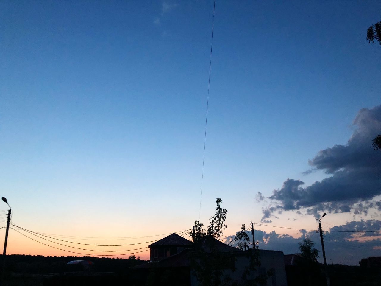 LOW ANGLE VIEW OF SILHOUETTE BUILDINGS AGAINST CLEAR SKY