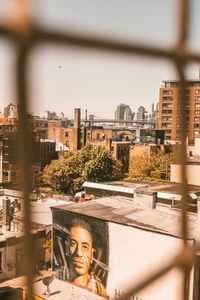 Portrait of buildings against sky in city