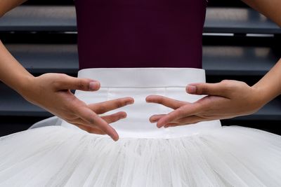 Midsection of couple holding hands